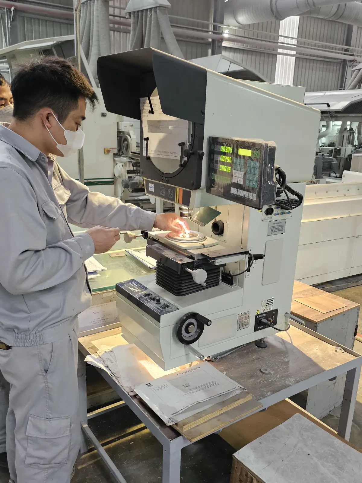 Worker checking SPC flooring profile for quality control